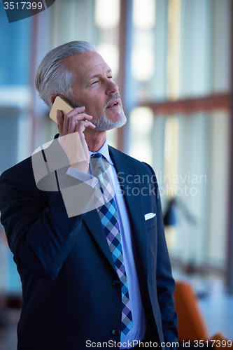 Image of senior business man talk on mobile phone