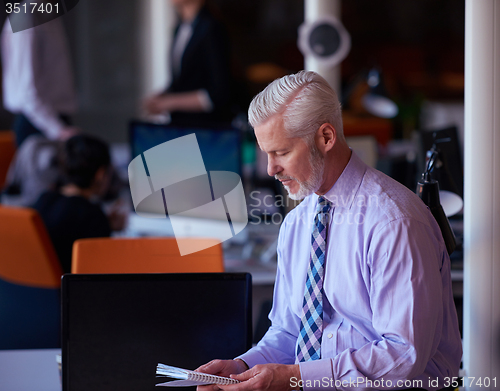 Image of senior business man with his team at office