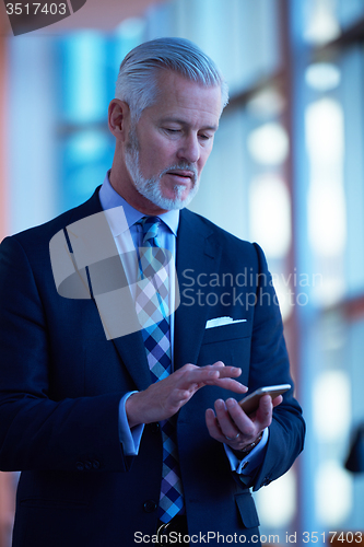 Image of senior business man talk on mobile phone