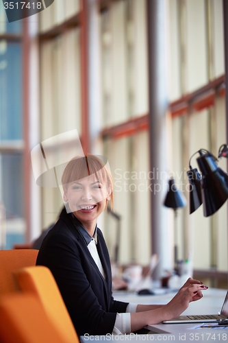 Image of business woman working on computer at office