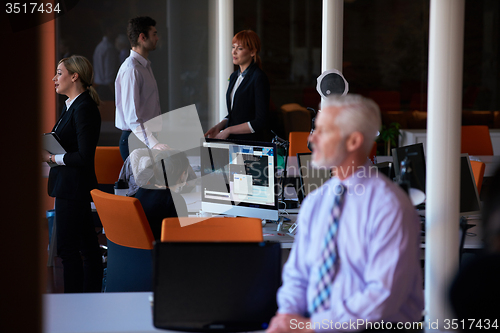 Image of senior business man with his team at office