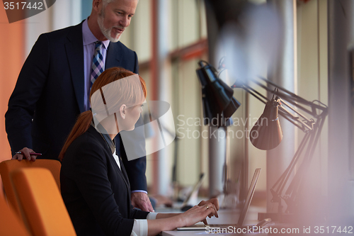 Image of business woman working on computer at office