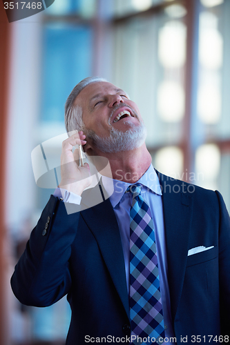 Image of senior business man talk on mobile phone