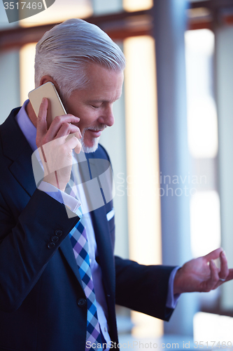 Image of senior business man talk on mobile phone