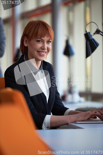 Image of business woman working on computer at office