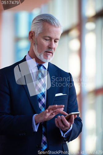 Image of senior business man talk on mobile phone