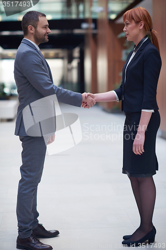 Image of business man and woman hand shake