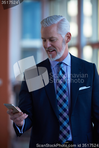 Image of senior business man talk on mobile phone