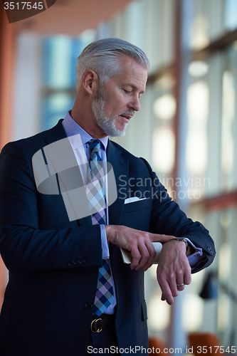 Image of senior business man talk on mobile phone