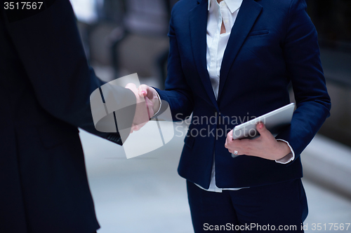 Image of business man and woman hand shake