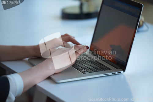 Image of business woman working on computer at office