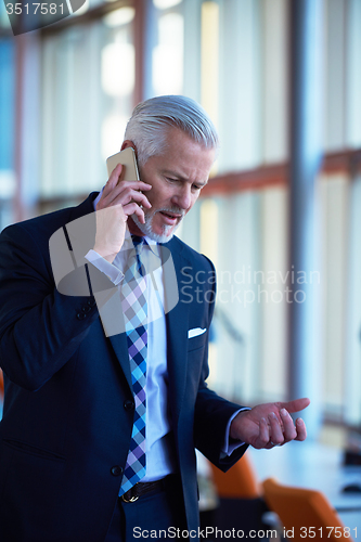 Image of senior business man talk on mobile phone