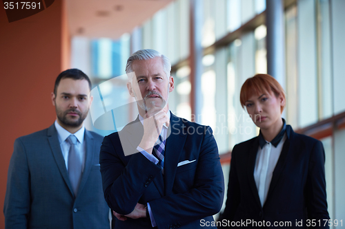 Image of senior business man with his team at office