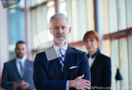 Image of senior business man with his team at office