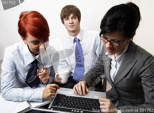 Image of confident young manager at work with laptop