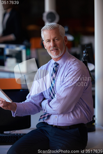 Image of senior business man with his team at office