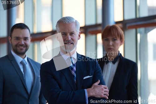 Image of senior business man with his team at office