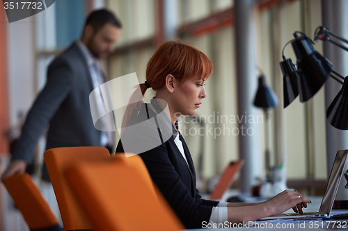 Image of business woman working on computer at office