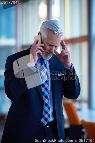 Image of senior business man talk on mobile phone