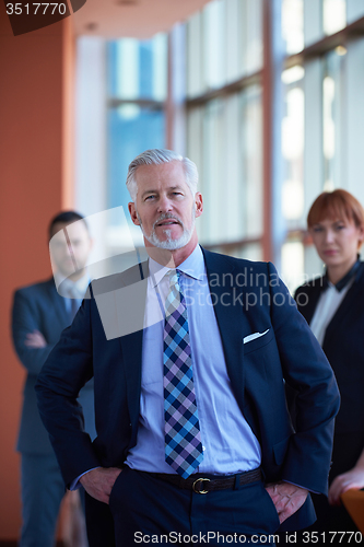 Image of senior business man with his team at office