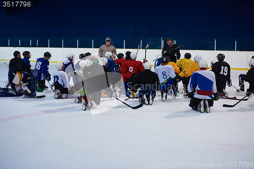 Image of ice hockey players team meeting with trainer