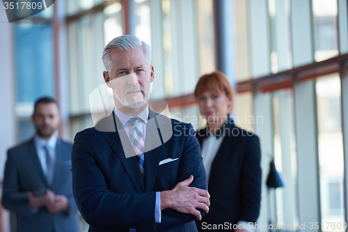 Image of senior business man with his team at office