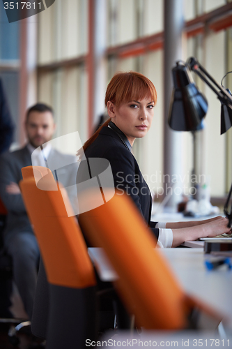 Image of business woman working on computer at office