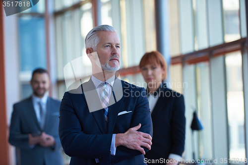 Image of senior business man with his team at office