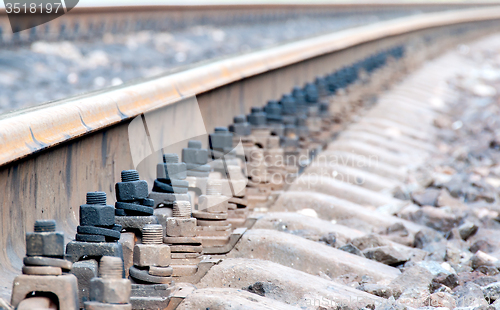 Image of Closeup of rails and sleepers leaving afar