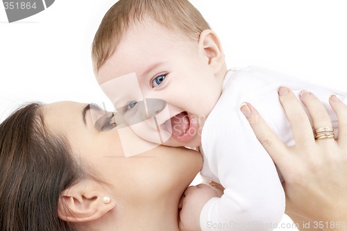 Image of laughing baby playing with mother