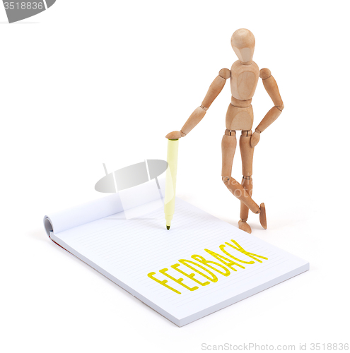 Image of Wooden mannequin writing - Feedback