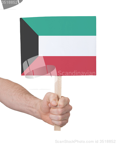 Image of Hand holding small card - Flag of Kuwait