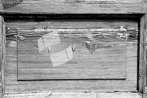 Image of grain texture of a brown antique wooden old door in italy   euro