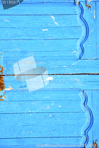 Image of dirty stripped paint in  blue wood door  