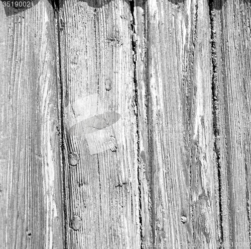 Image of grain texture of a brown antique wooden old door in italy   euro