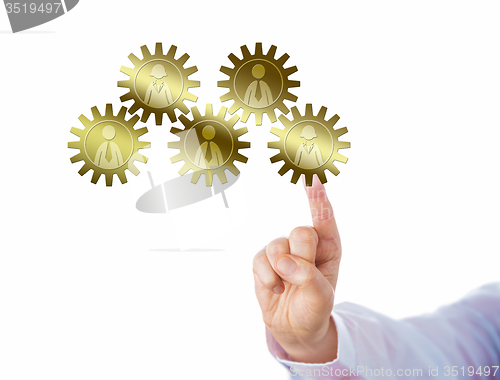 Image of Hand Touching A Golden Gear Train Of Five Workers
