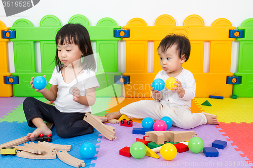 Image of Asian Chinese childrens playing with blocks