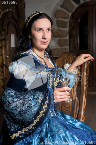 Image of Attractive woman in red dress in retro baroque style