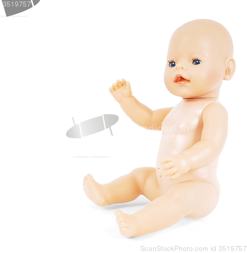 Image of Little naked girl baby doll with blue eyes waving towards white