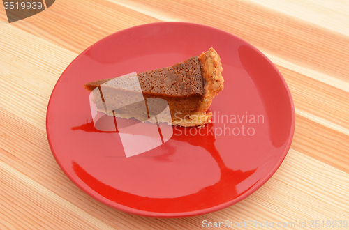 Image of Red plate with a slice of pumpkin pie