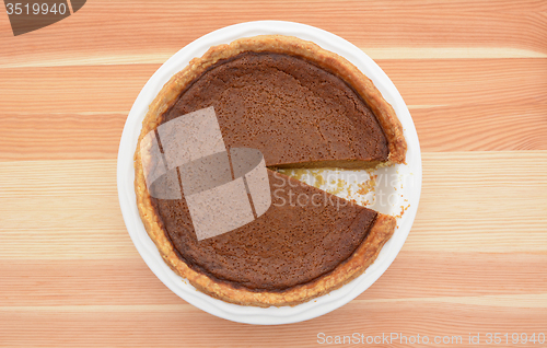 Image of Pumpkin pie with one slice taken