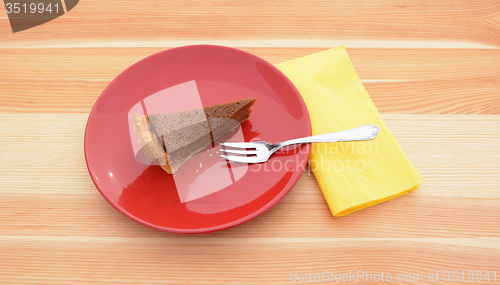 Image of Slice of pumpkin pie on a red plate