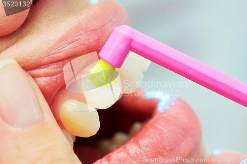 Image of Dentist showing a woman how to brush her teeth