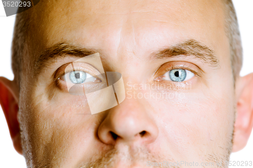 Image of blue-eyed man. The face close up. Studio. isolated