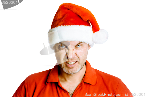 Image of Unshaven angry man in a red shirt and Santa hats. Studio. isolat