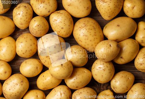 Image of potatoes on wooden background