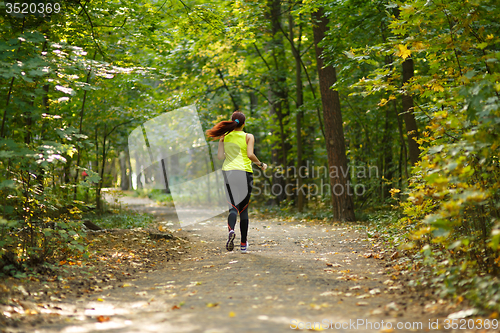Image of woman running at forest