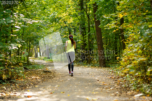 Image of woman running at forest