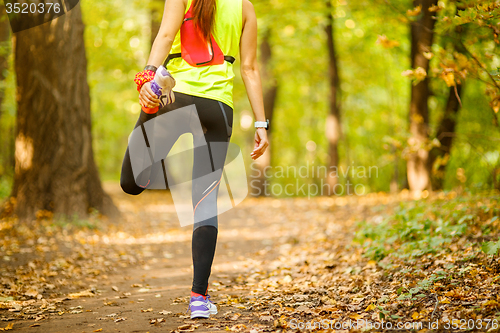 Image of Detail of woman stretching legs 