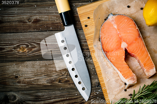 Image of Fresh and raw steaks trout on wooden cutting